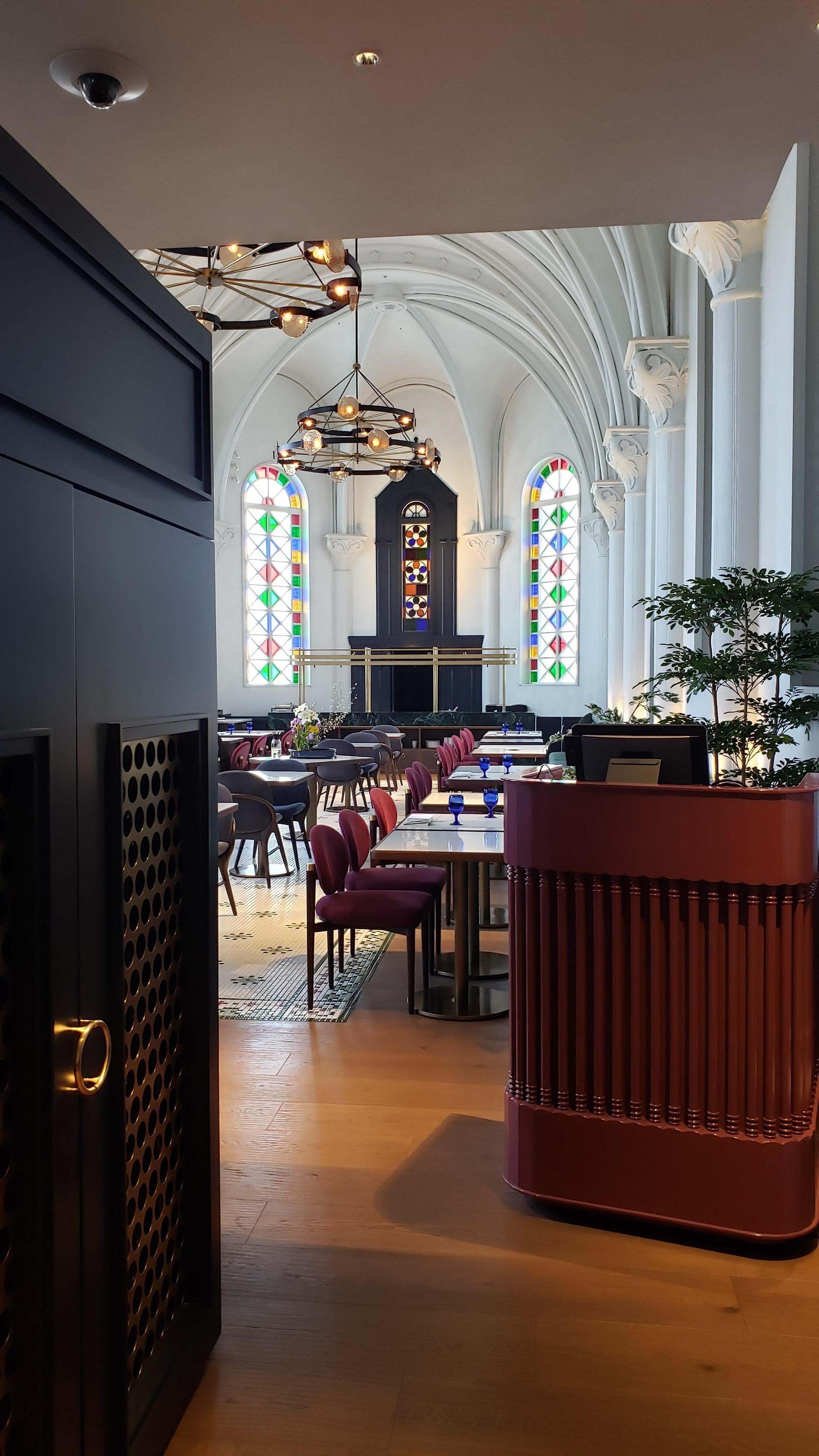 The dining area features stained glass, true to the history of the surrounding neighborhood. 