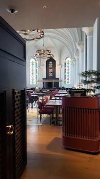 The dining area features stained glass, true to the history of the surrounding neighborhood.
