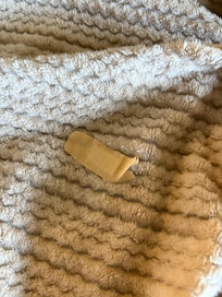 Old bandaid stuck to a “clean” blanket in the closet.