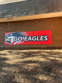 Go Eagle Banner on the Gym brick wall so CQQL and neatly.