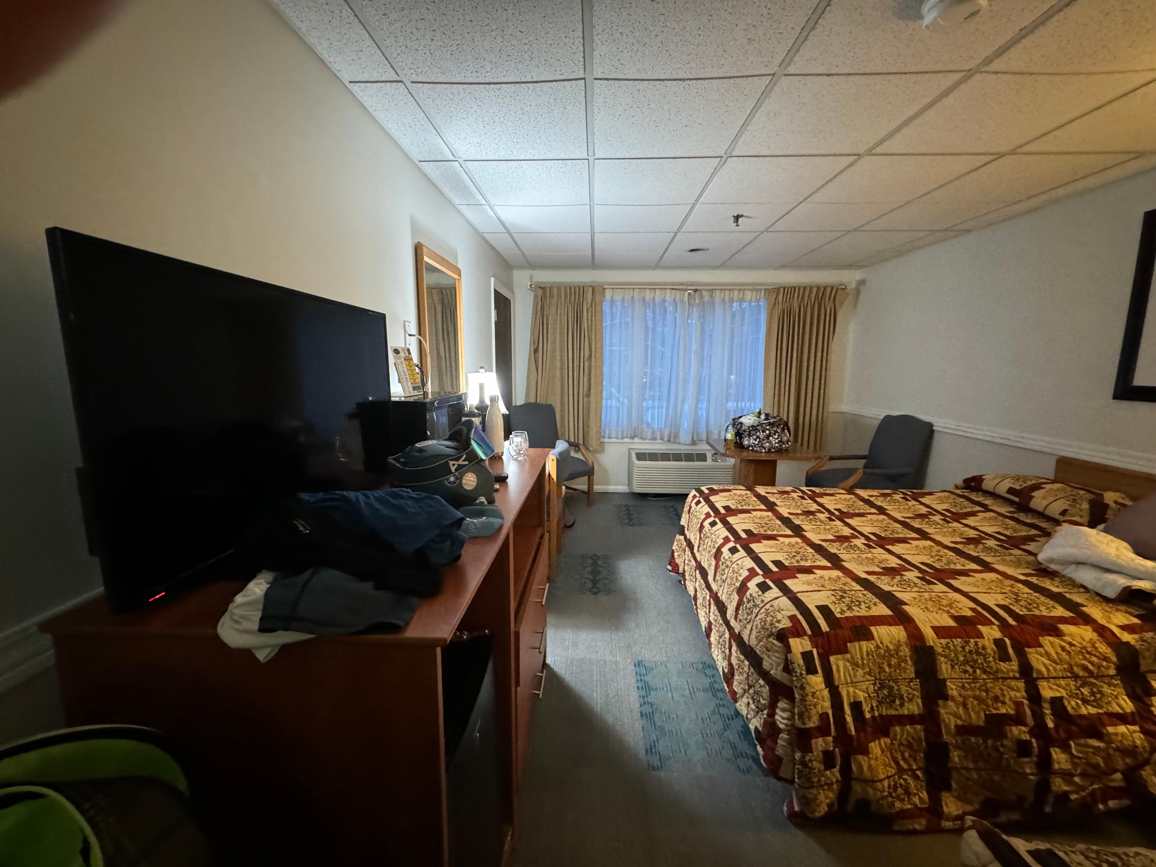 A table, fridge, microwave, and tv.