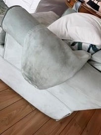 Armrest on the den chairs to dirty to wear a white shirt and sit down.