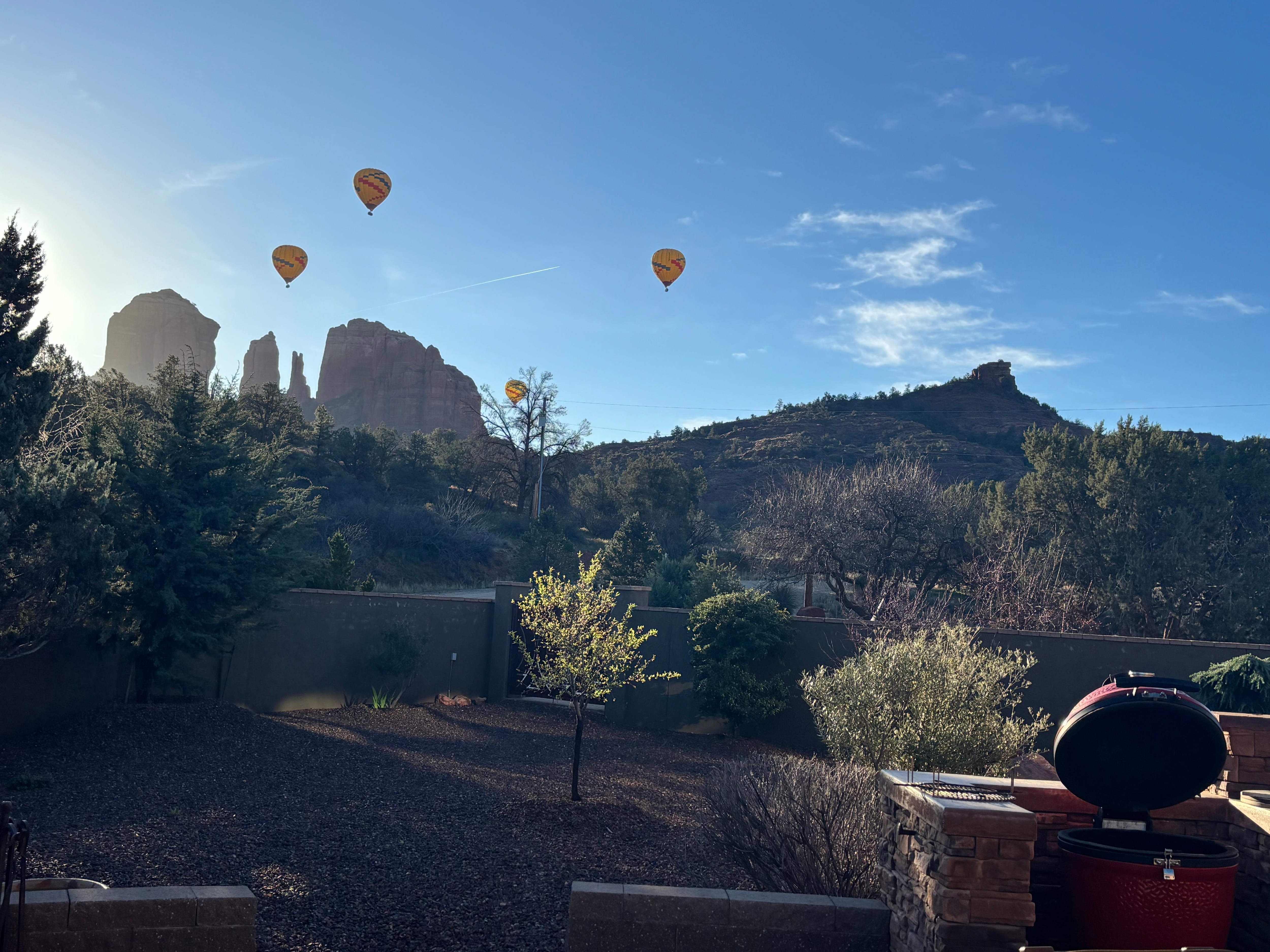 View from deck/patio/bbq area. Hot air balloons flying over
