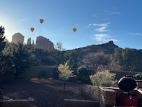 View from deck/patio/bbq area. Hot air balloons flying over