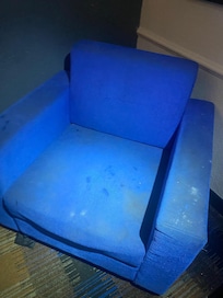 Stained chair with god knows what and there’s a pile of eaten sun flower seeds on the side of it.