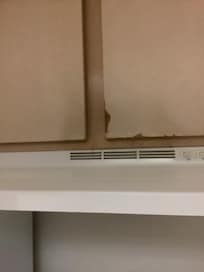 Discolored and broken cabinets.