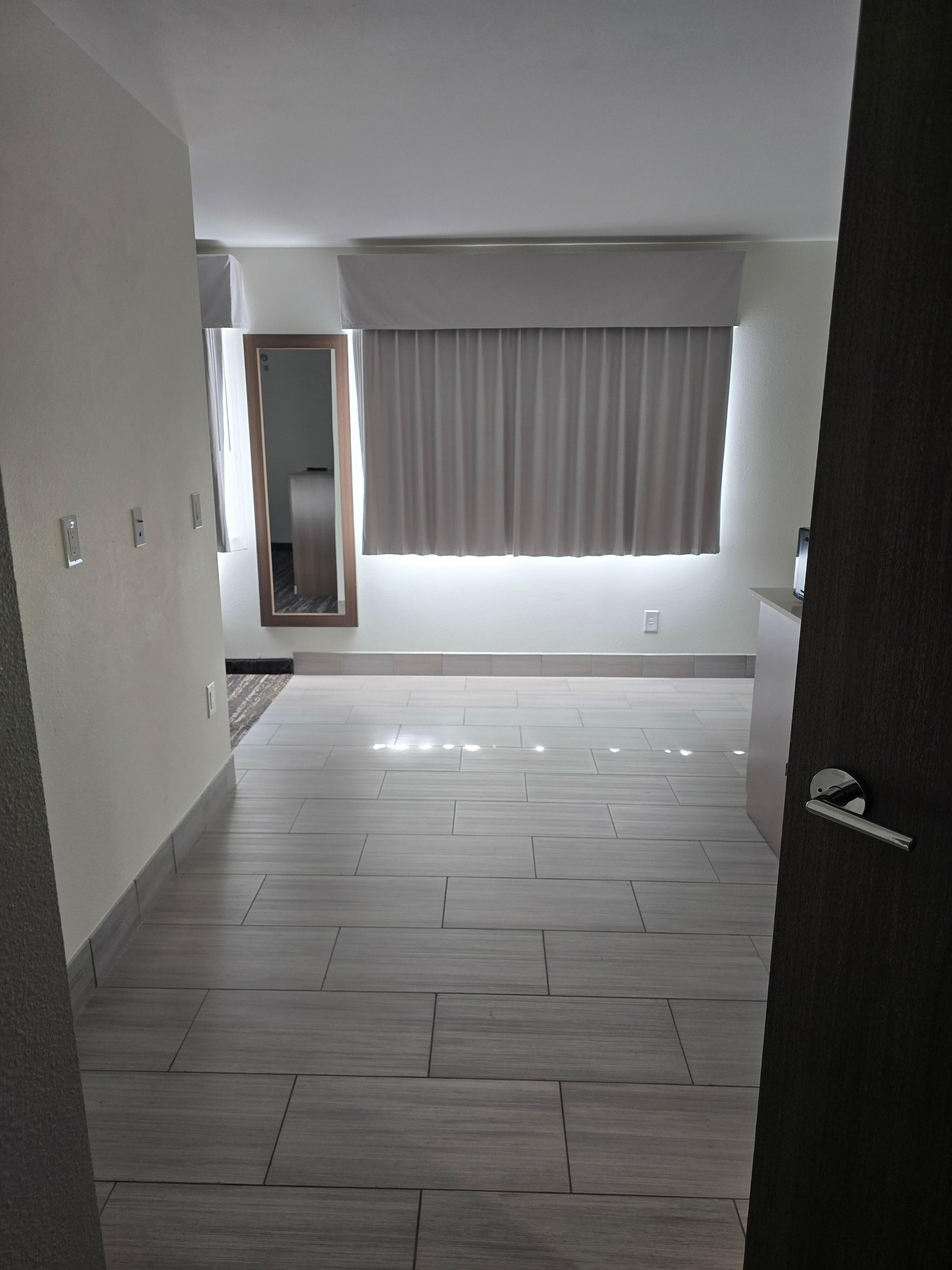 View walking in door. Bathroom & kitchen to right, beds to left