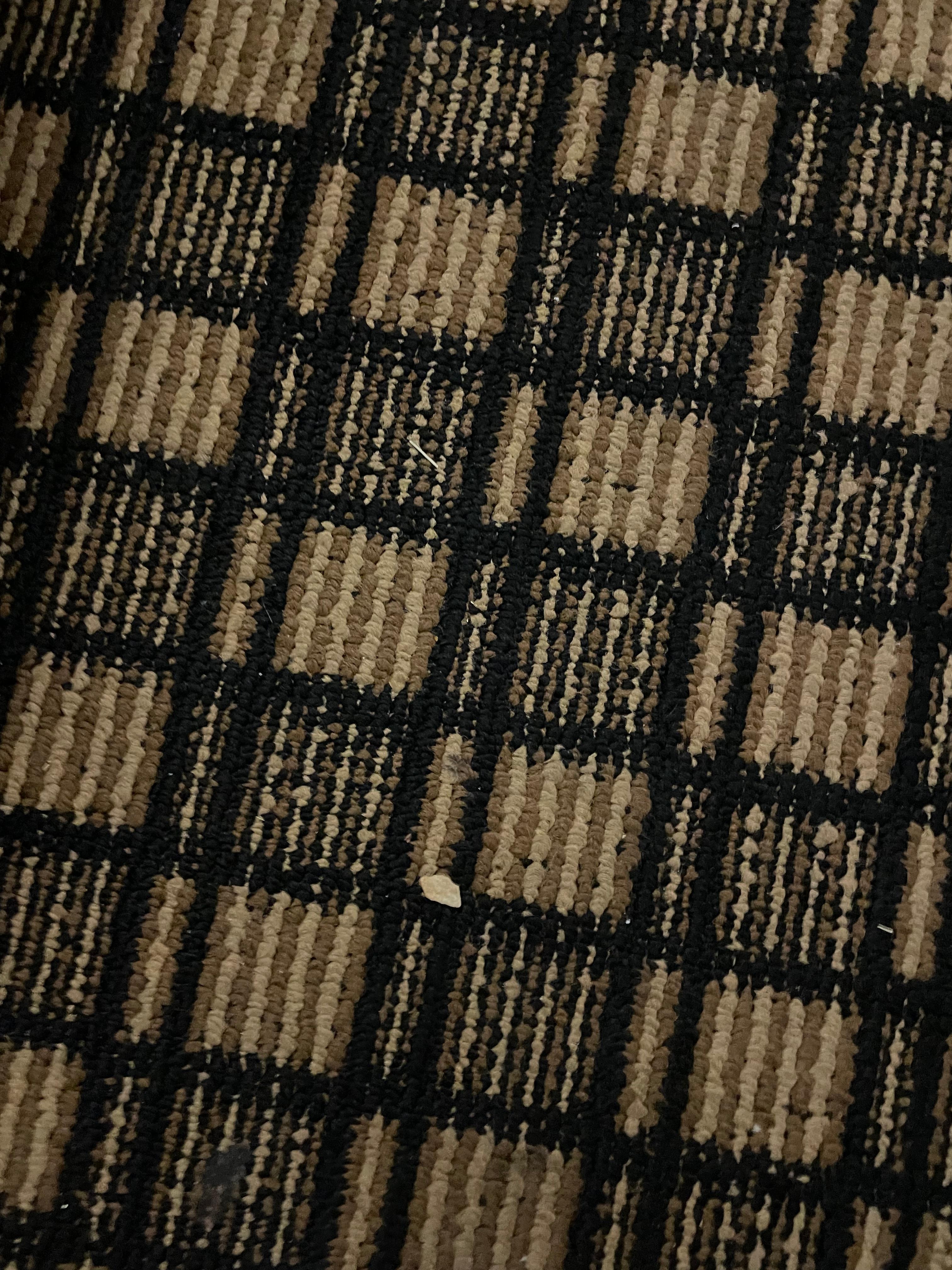 One of many scraps of paper, debris all over the carpet.