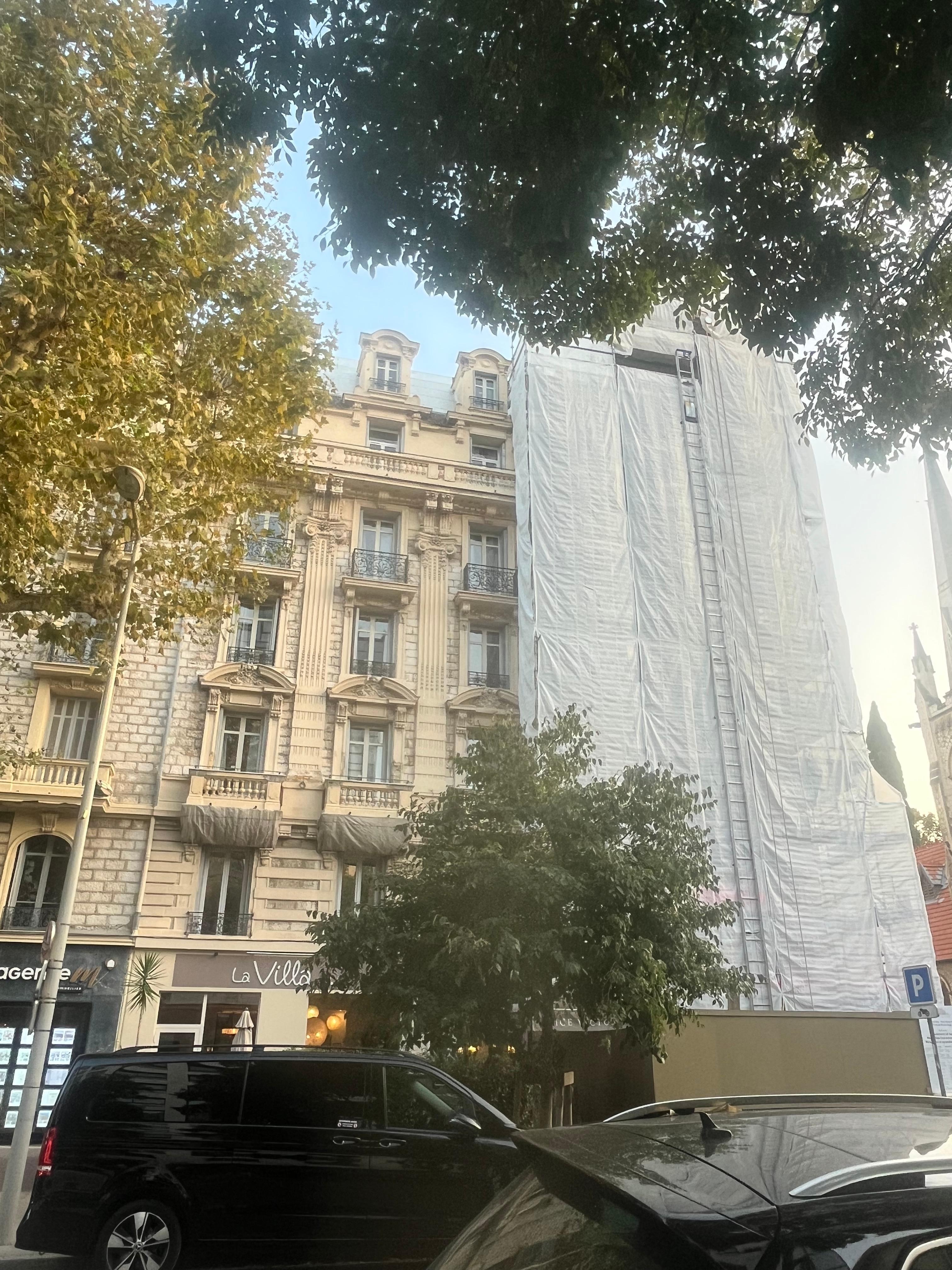 Scaffolding and tarpaulin covering most of the hotel