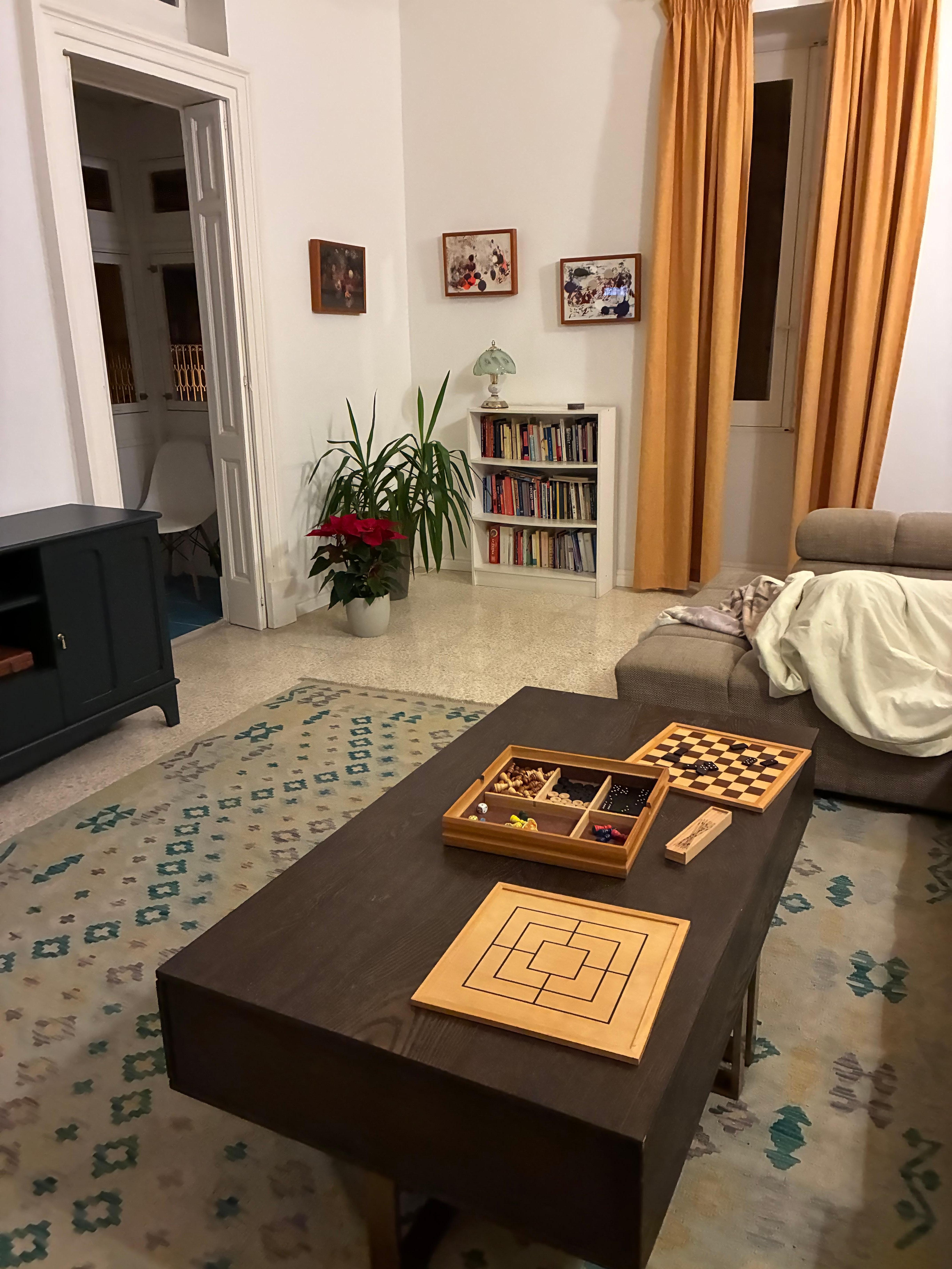 Huge living room with big sectional and tv and small inclosed balcony