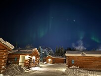 Northern lights by cabins
