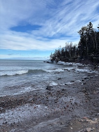 Walk down short trail across the street to sandy Lake Superior beach.