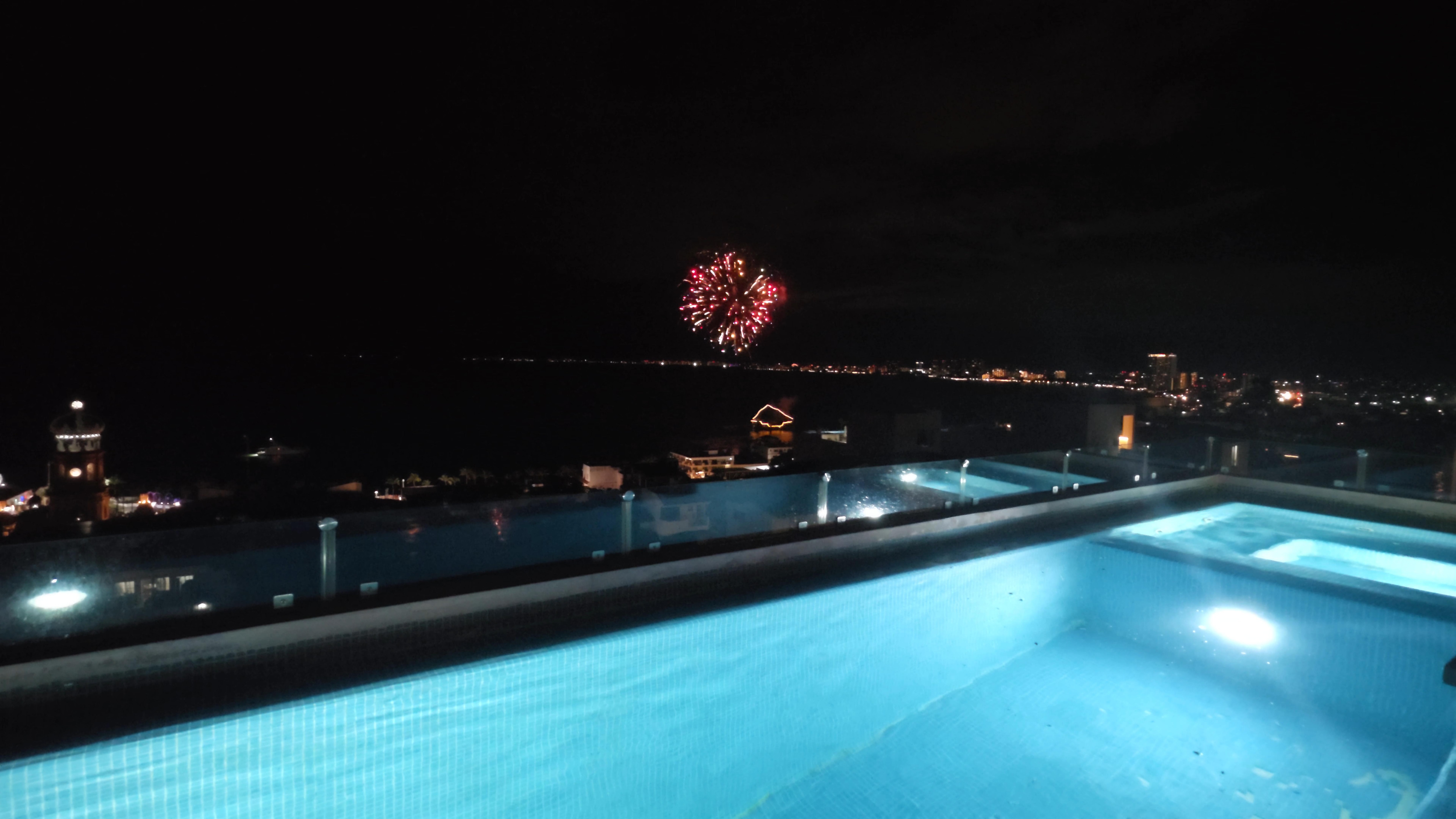 Night fireworks from pirate ship on top of roof