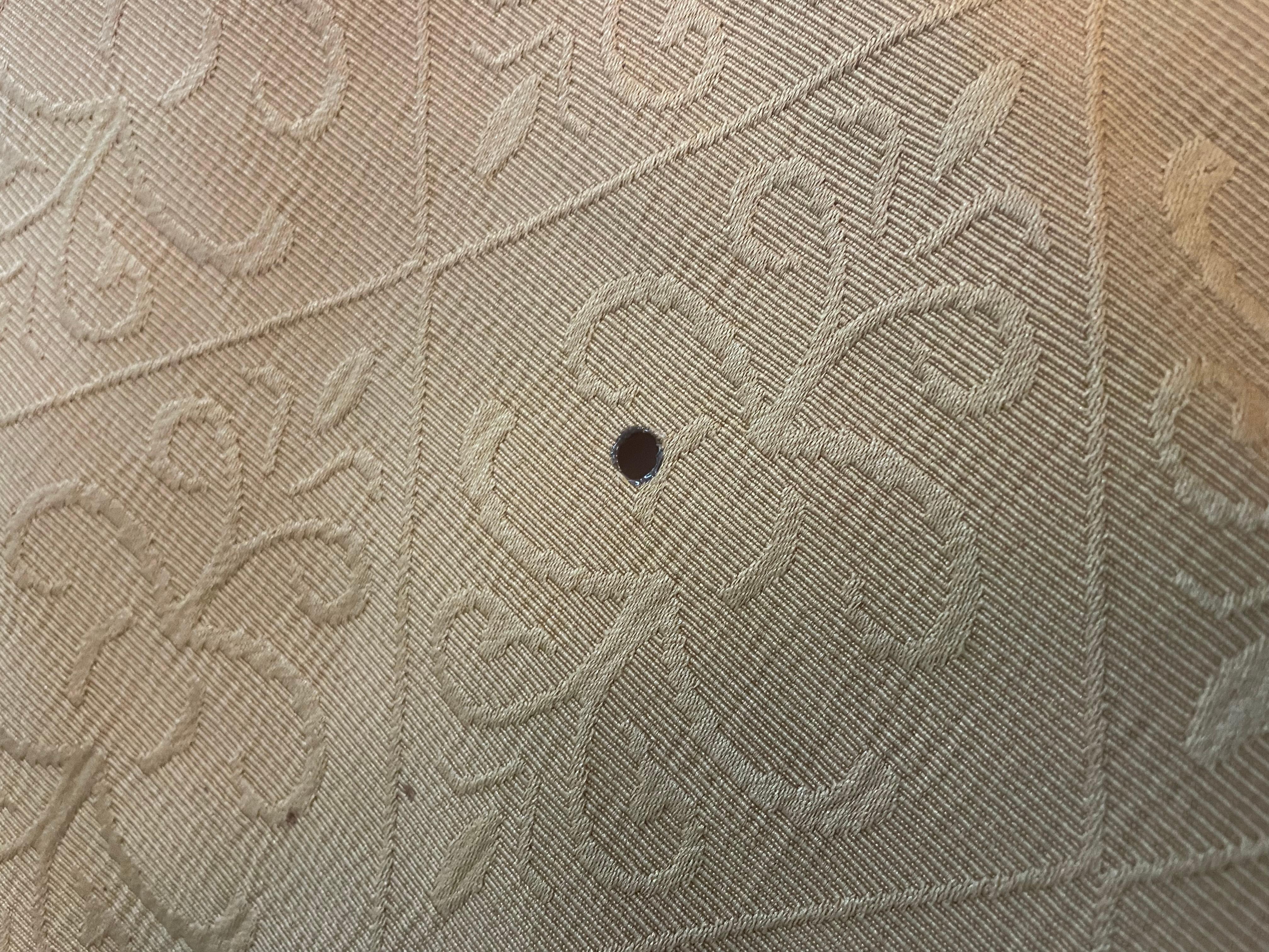 One of 3 holes in the blankets from cigarettes