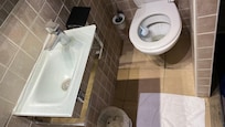 Must slide oneself to sit on the toilet.
