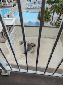 On balcony looking at pool over trash area