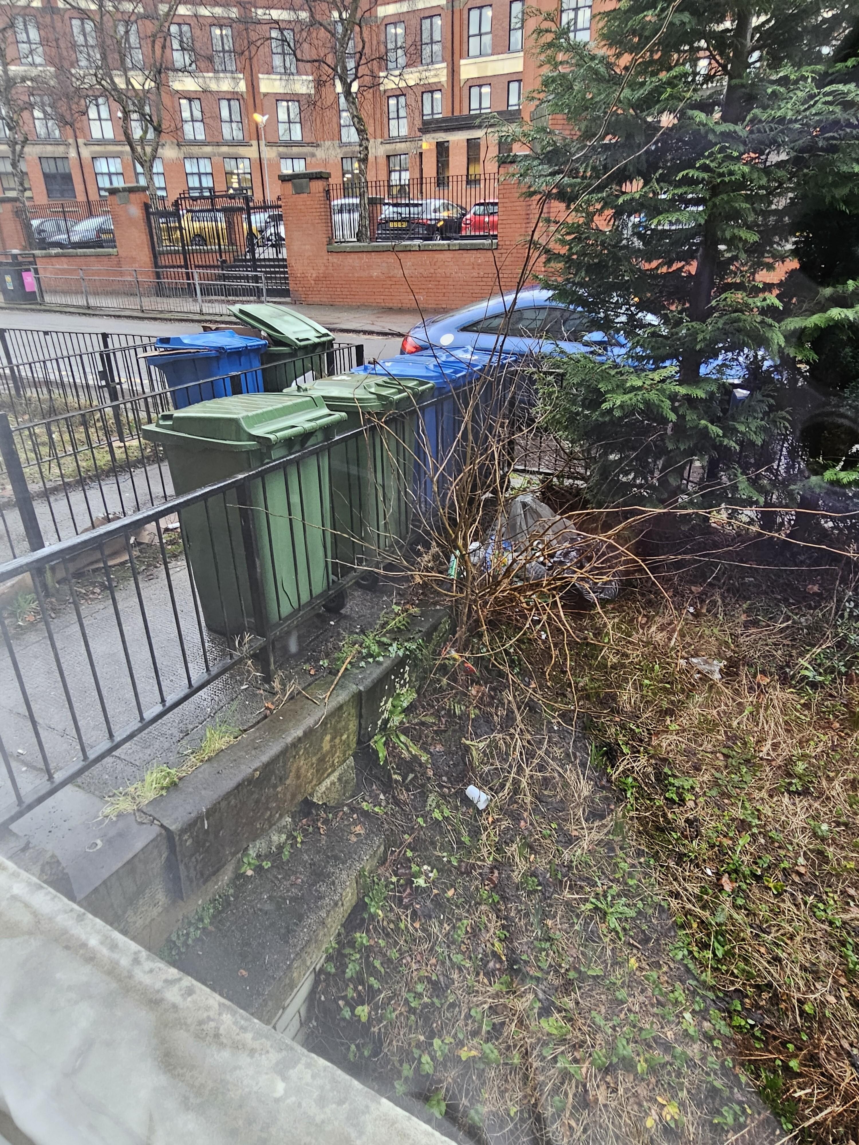 gray trash bag with trash in the grass right in front there the entirety of my stay