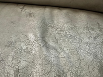 Uncomfortable couch due to cracks and stains