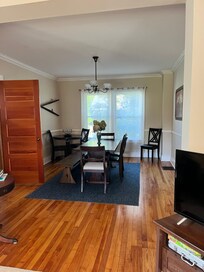 Dining area. Door open on left leads to a full bathroom that appears to be more recently renovated.