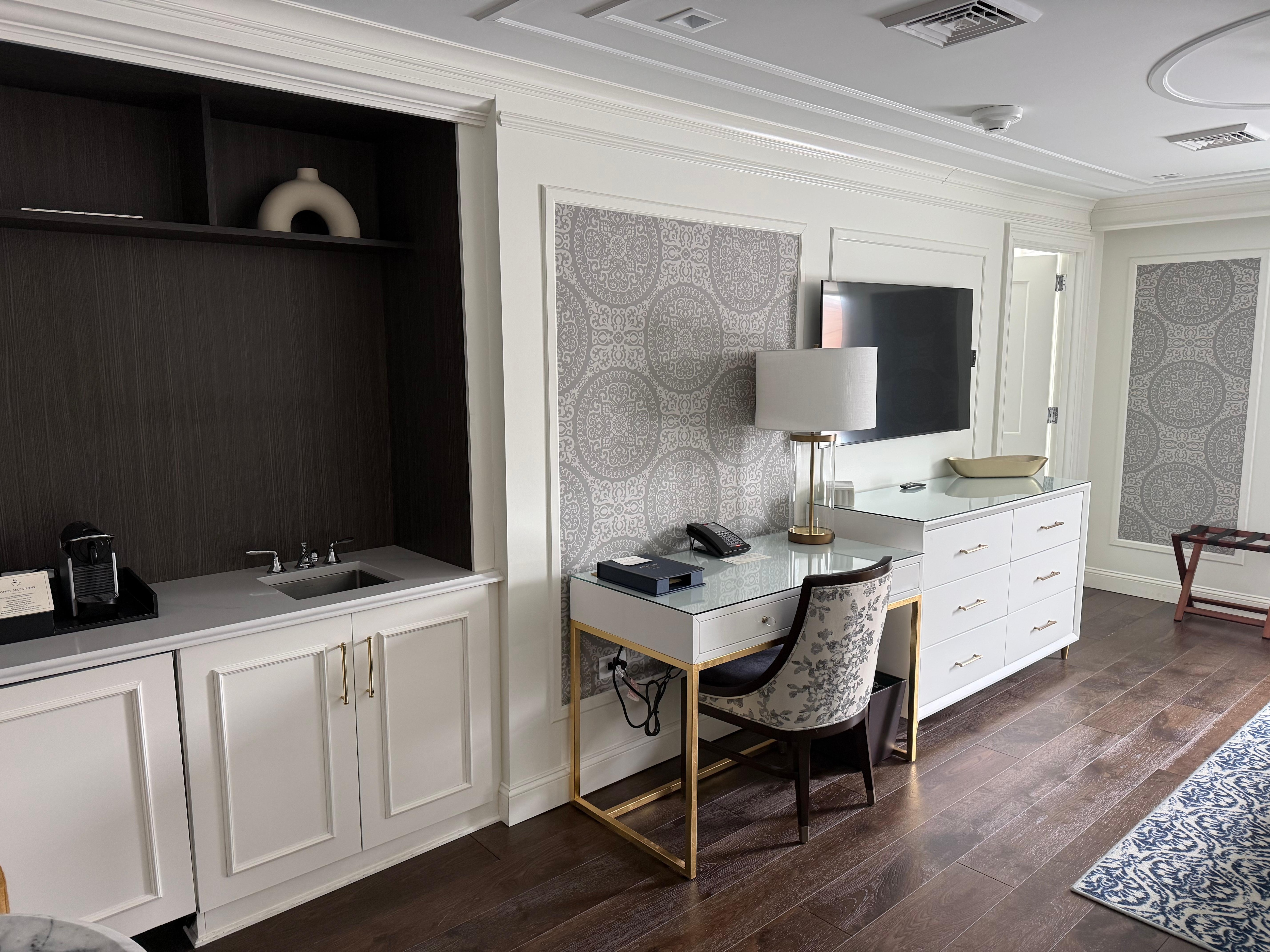 Large suite with wet bar, cafe table and work station.