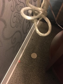 Trash behind night stand