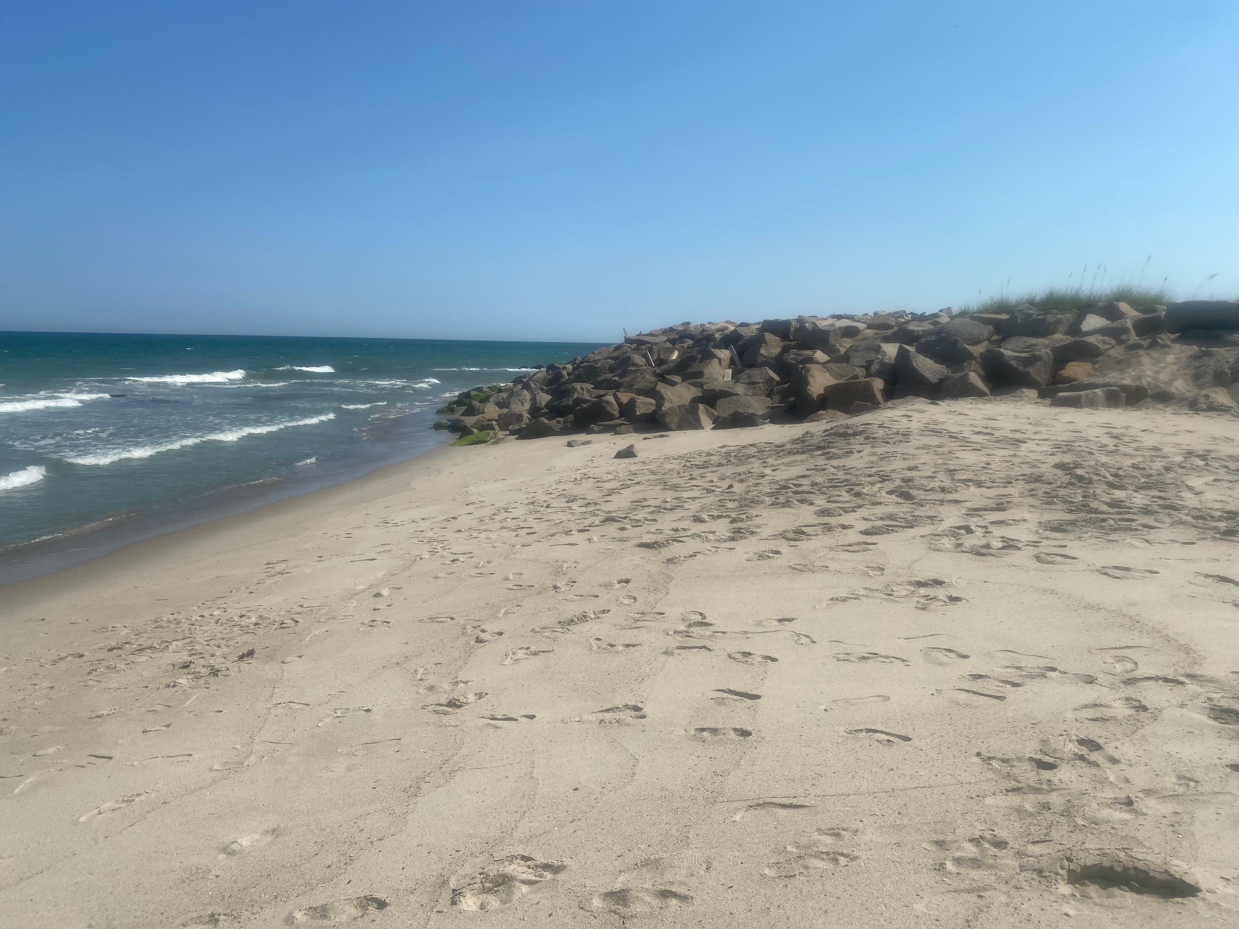 Beach on far side of the condos with the natural rocks. 