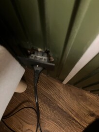 Wall plug in bedroom hanging from wall