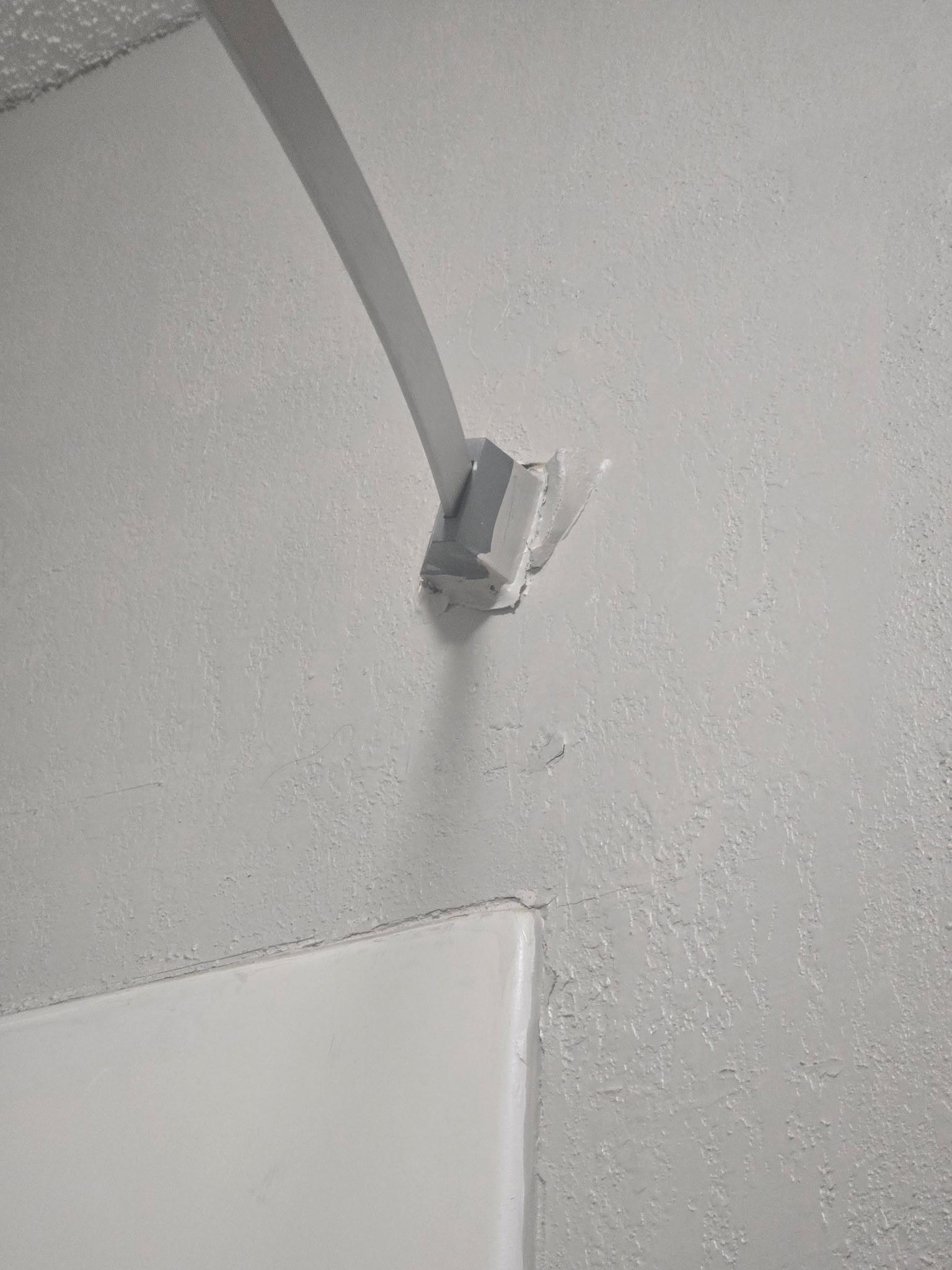 Curtain rod falling off the wall.