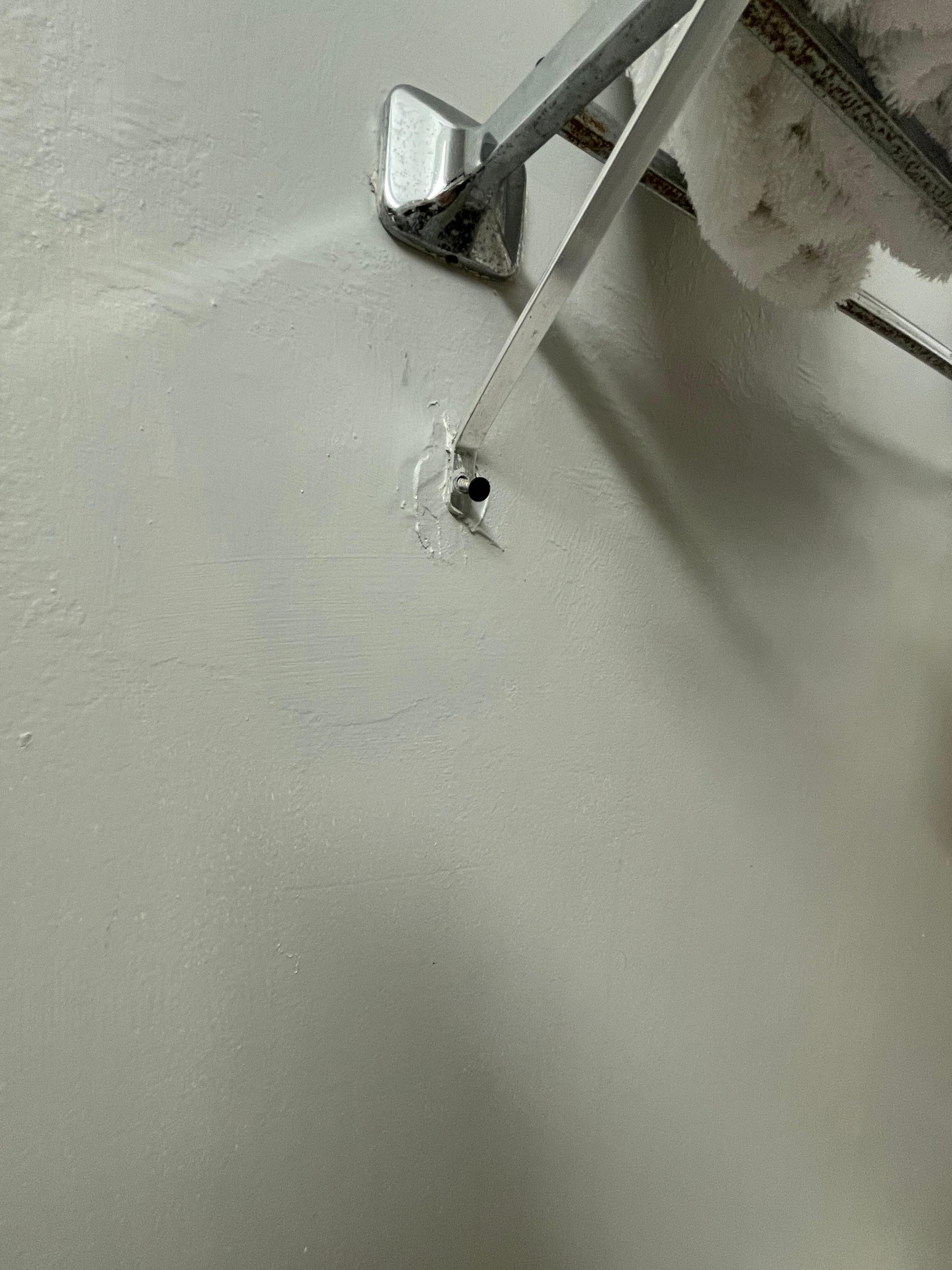The shelf was warped, and ready to fall! Look at the screw!