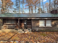 Front of the cabin with Charmin the bear.