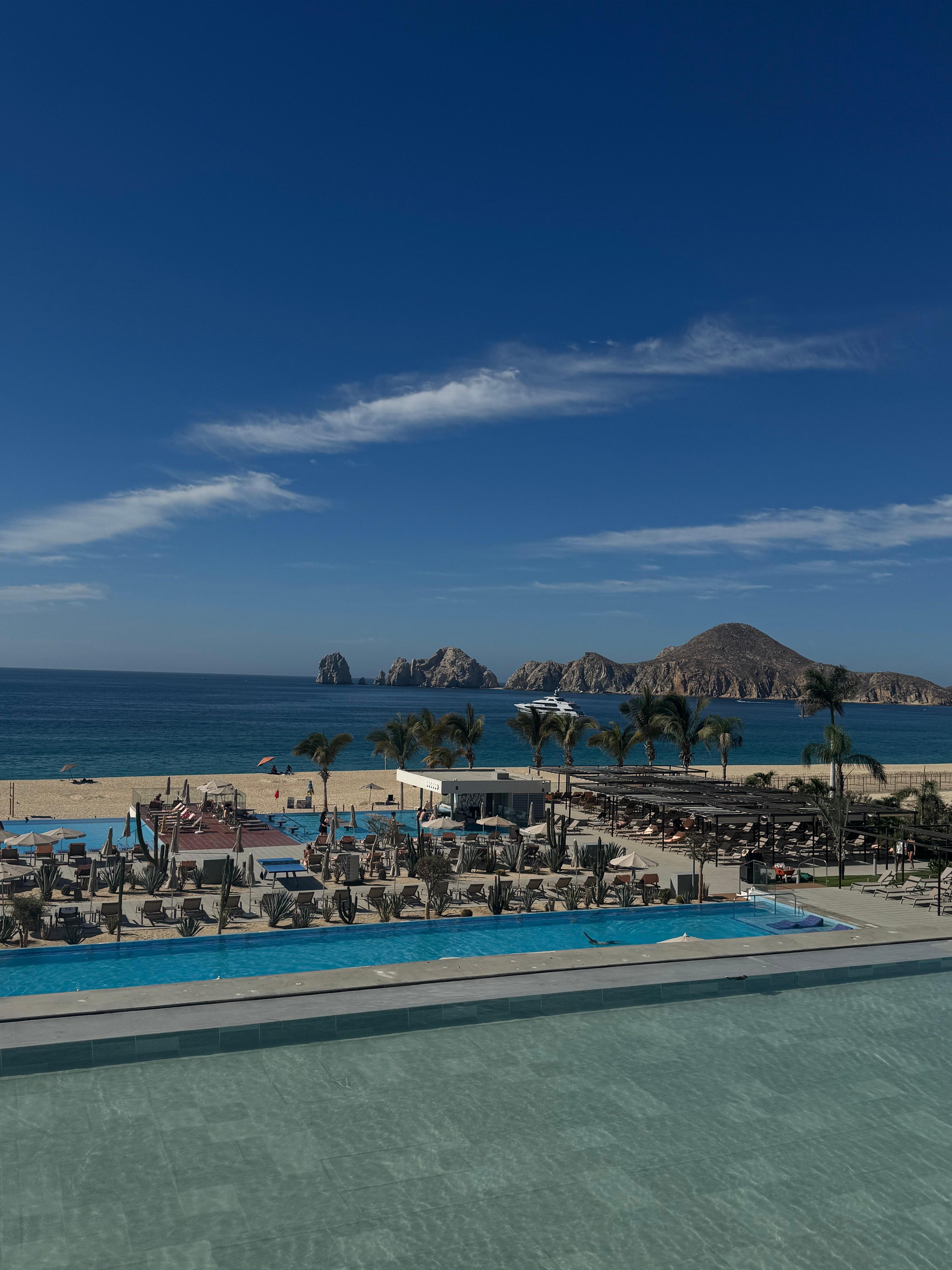 Main pool view with beach and arches 