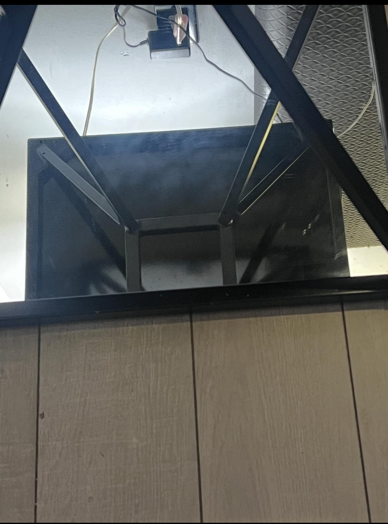 The table with the mirror not clean withe smears all over it.