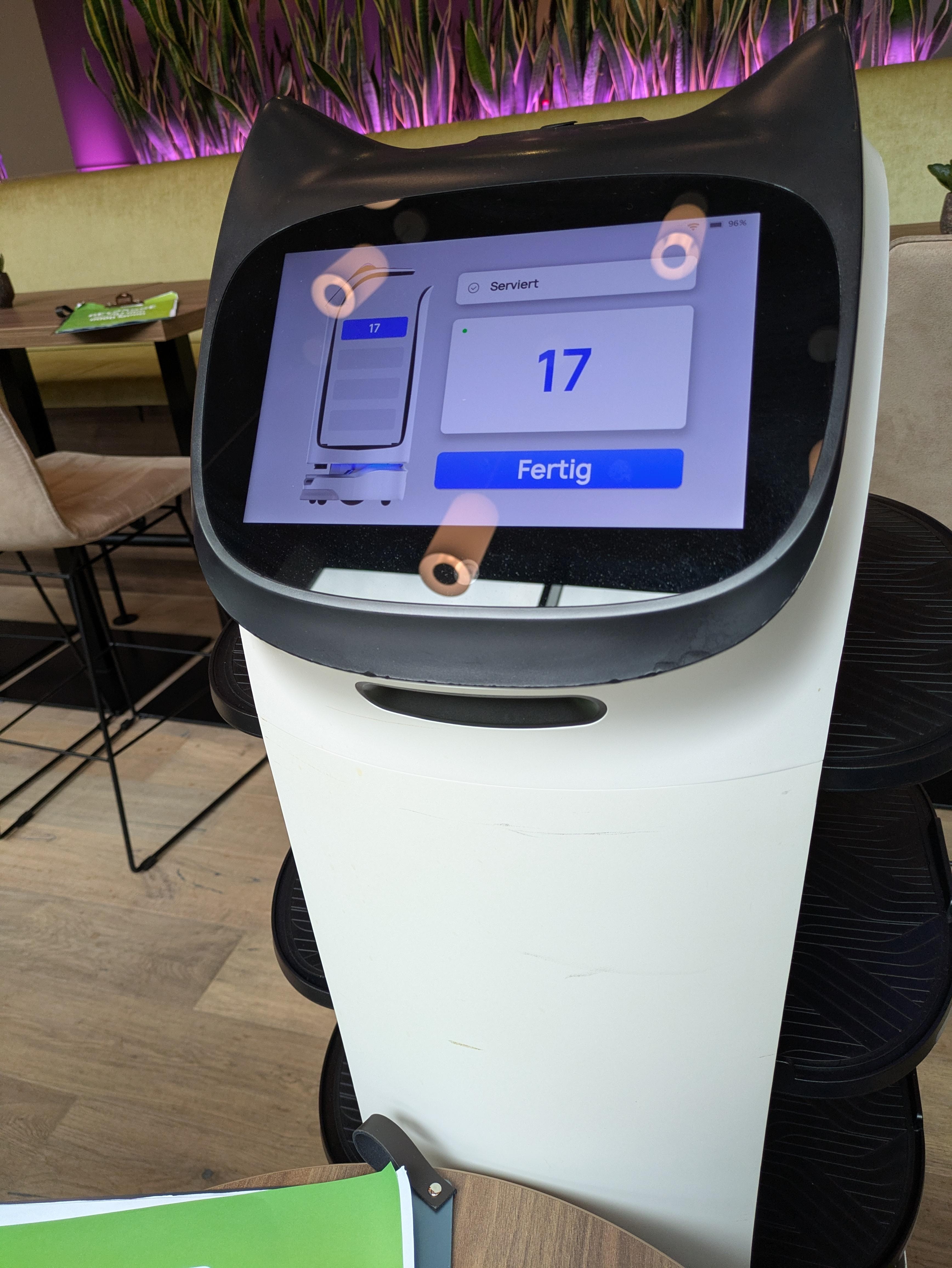 Bella the cat robot who delivers food and drinks in the hotel restaurant.
