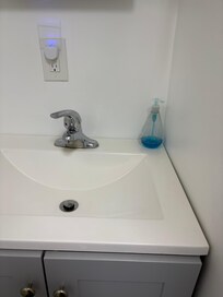 Almost empty soap dispenser. No extra toilet paper.