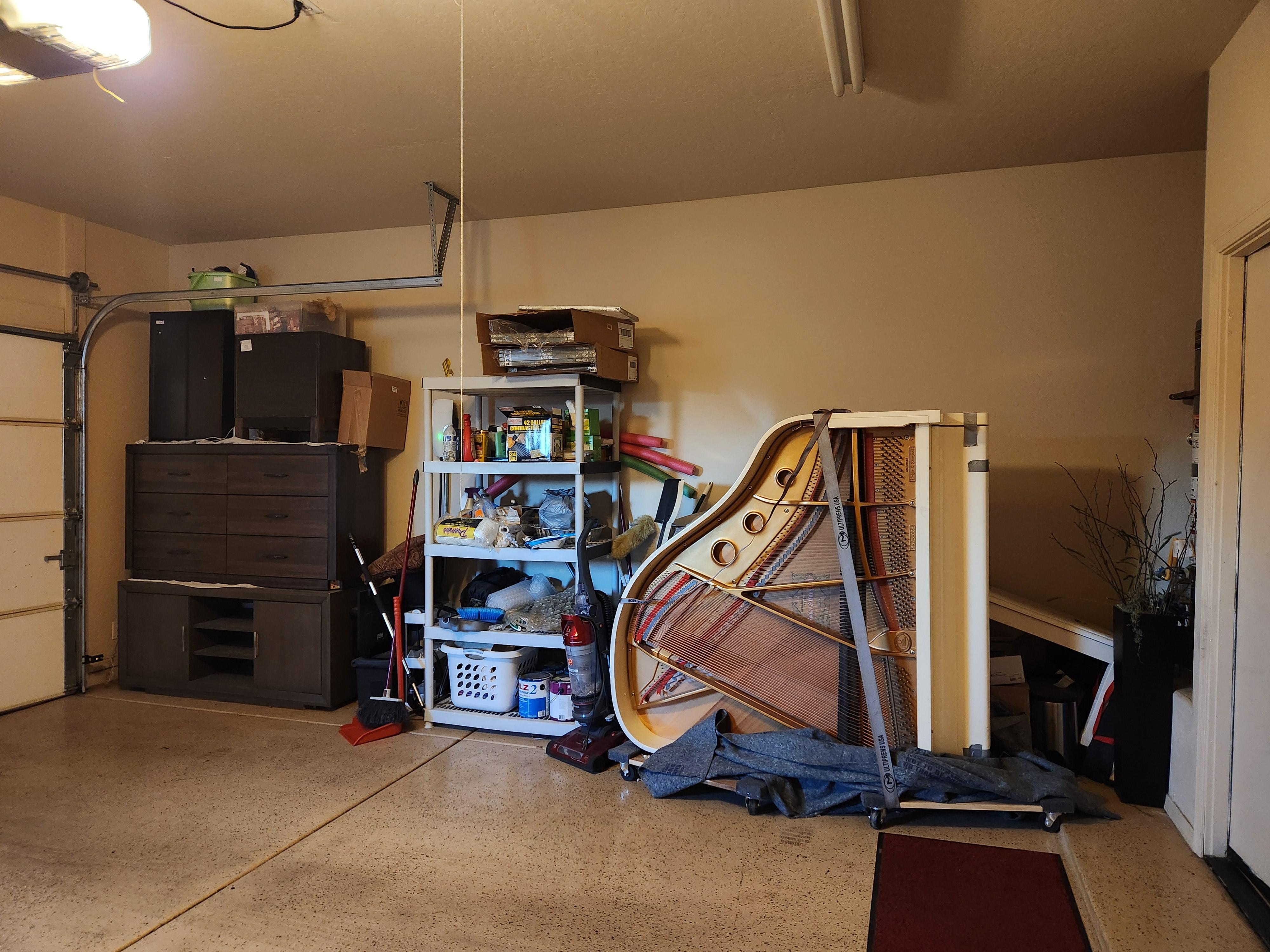 Storage inside garage. Other side had garbage and recycling bins. Two cars parked would be tight.