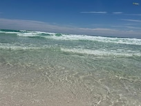 Steps from the clear, emerald waters of the Gulf