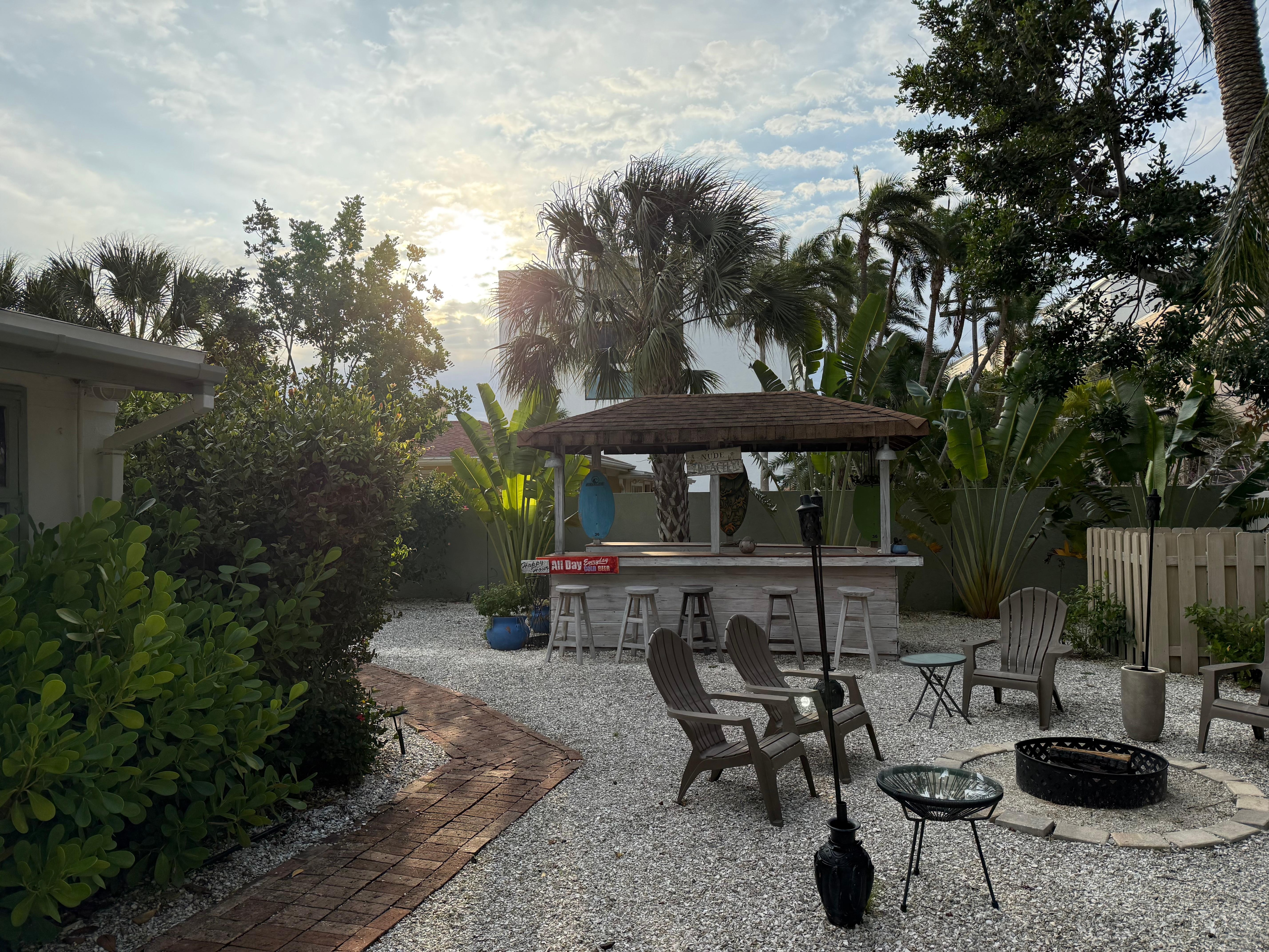 Backyard is huge and includes a tiki bar, fire pit, hammock and lots of chairs to relax in. 