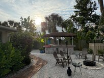 Backyard is huge and includes a tiki bar, fire pit, hammock and lots of chairs to relax in.