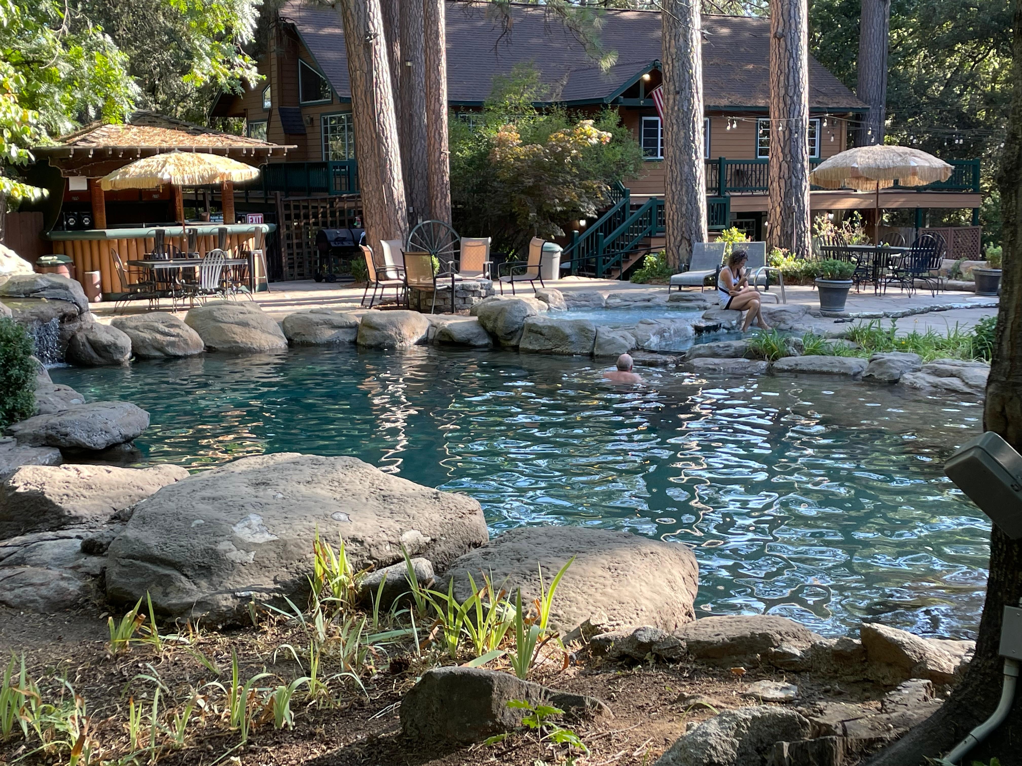 Pool and hot tub with club house behind