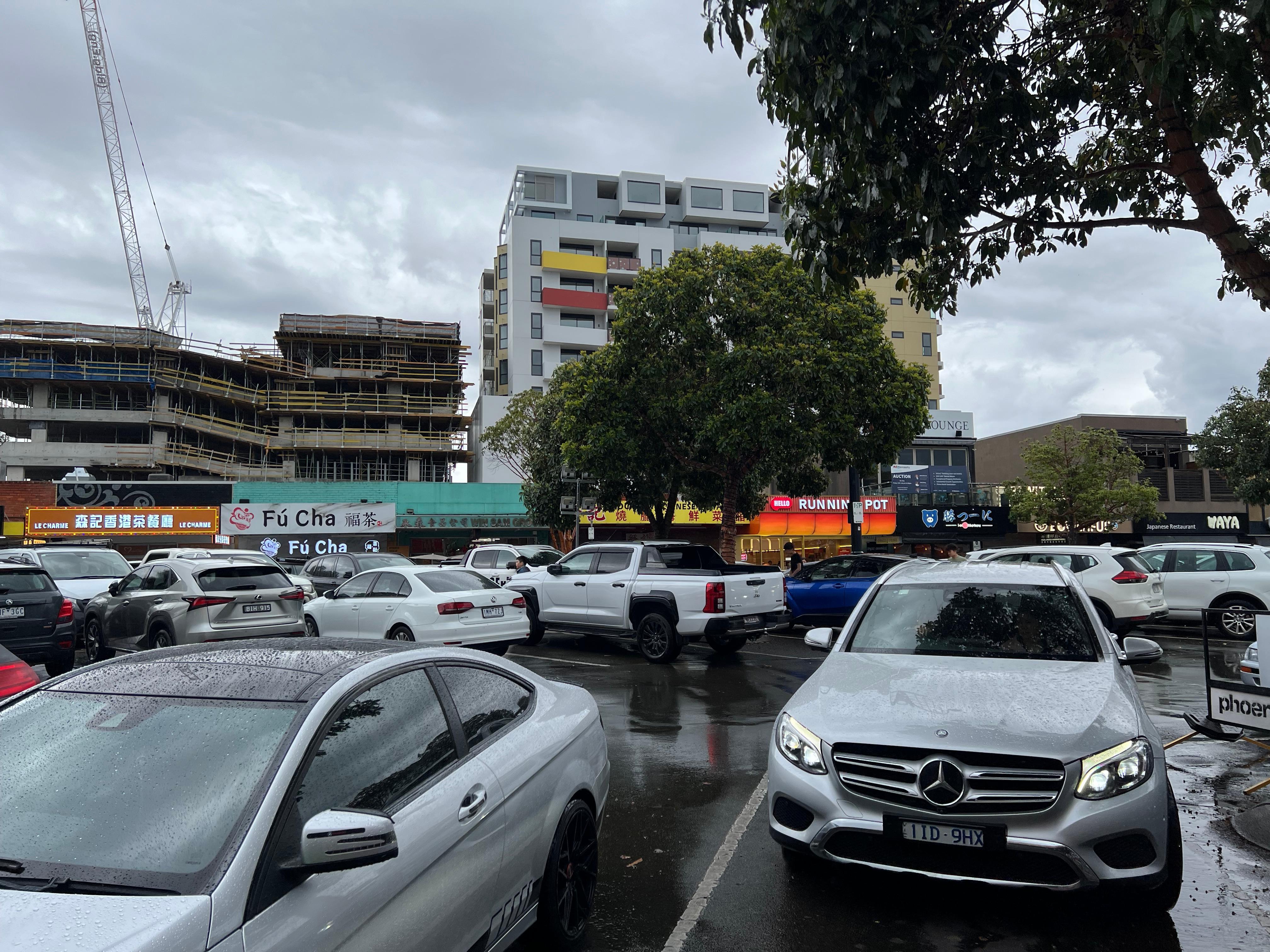 Street across the apartments where eateries and restaurants are 