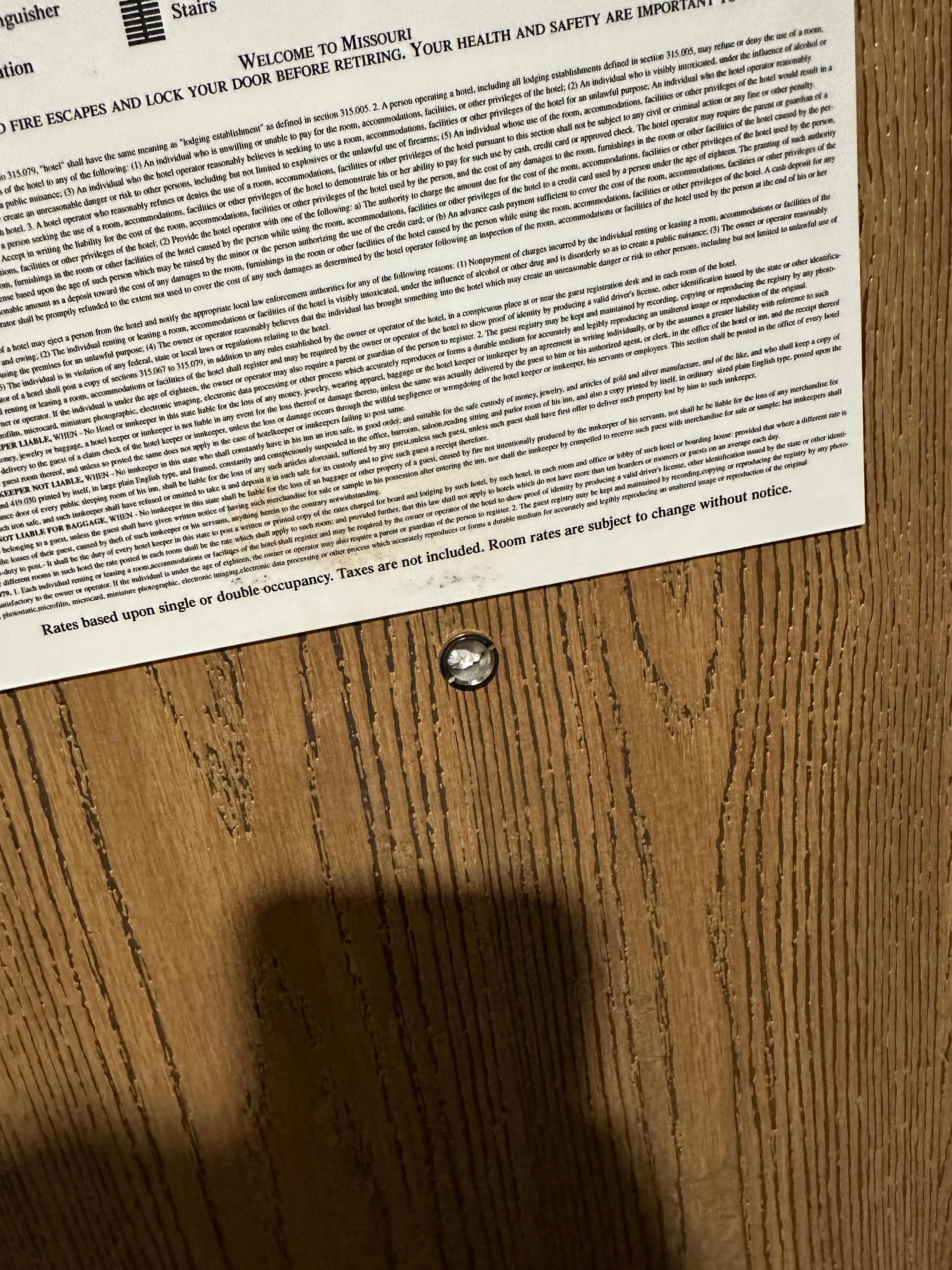 Tissue stuff in peep hole, and weird stuff on door sign.