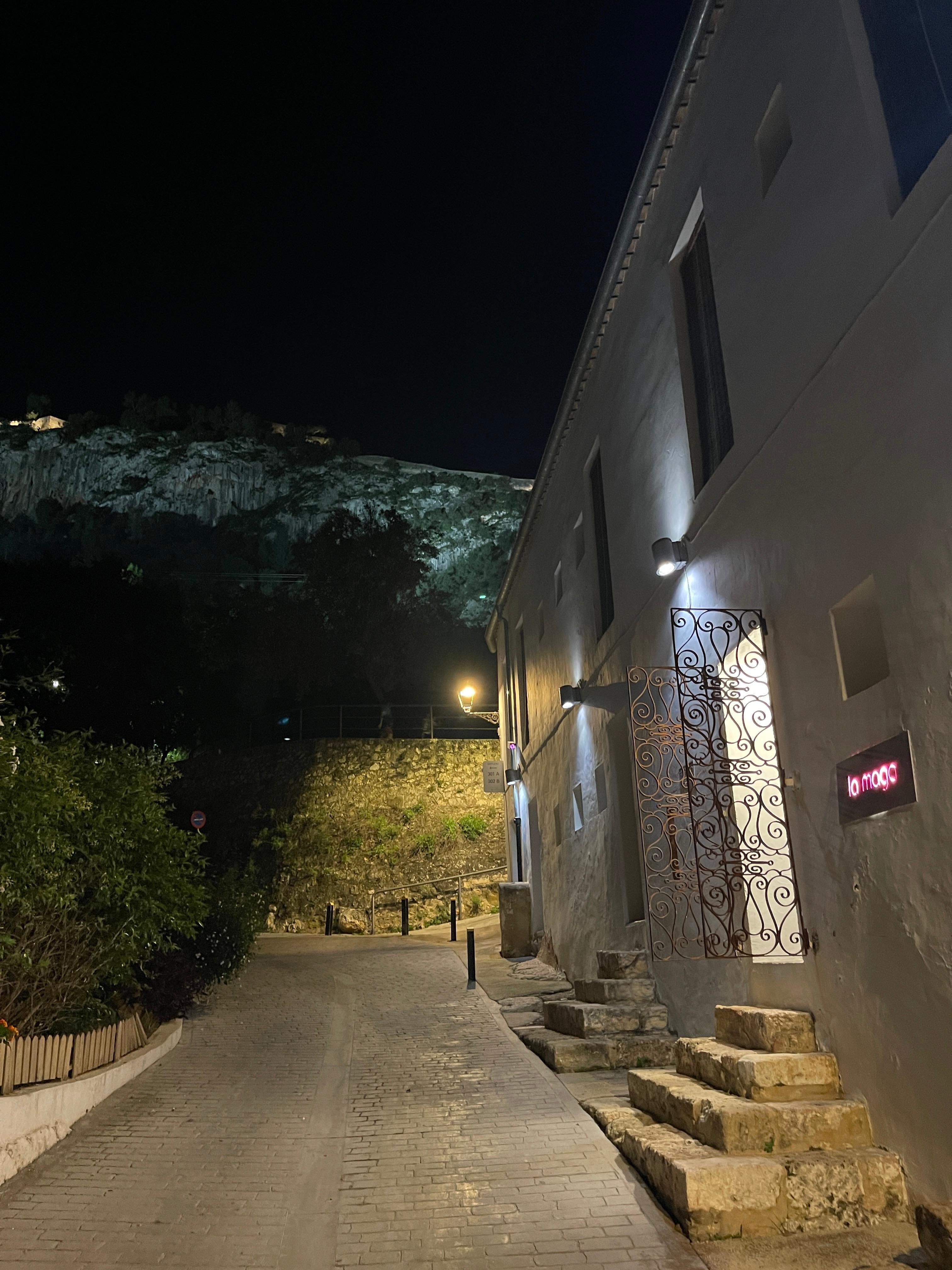 Inngangen til hotellet om kvelden med den opplyste borgen i bakgrunnen