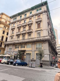 Outside of the building waiting for our taxi. The a no morning we left Naples.