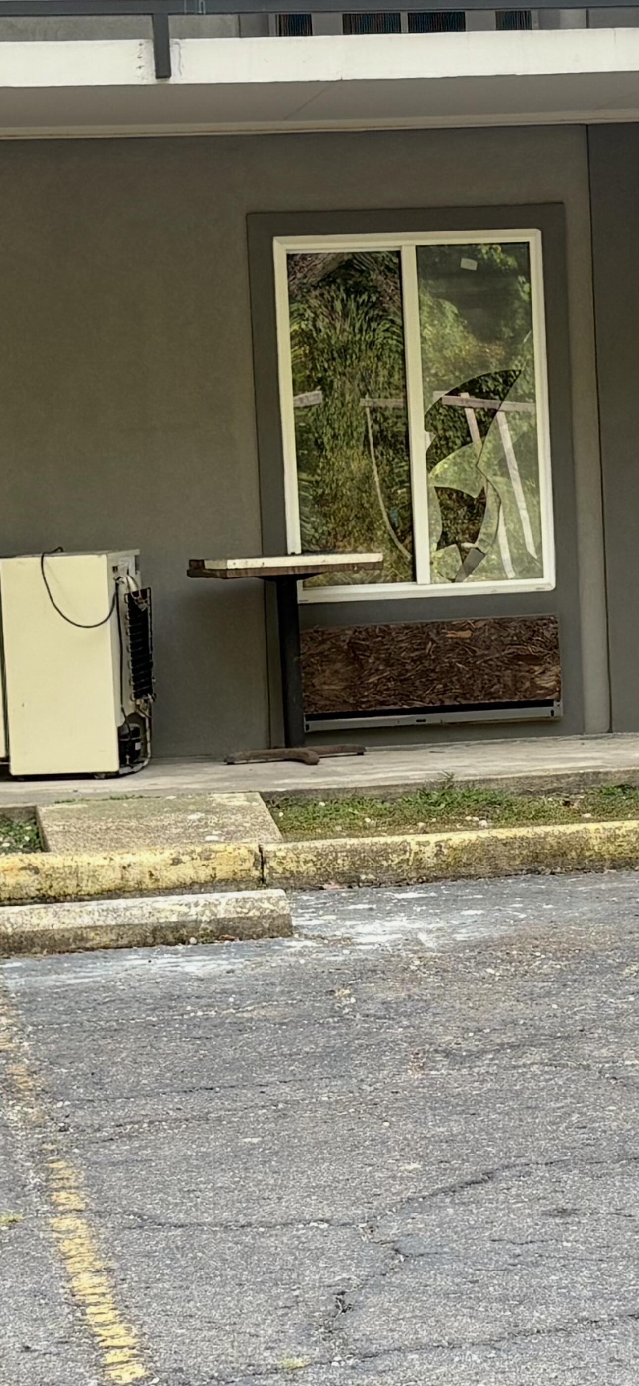 Unkept property with trash and broken windows 