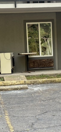 Unkept property with trash and broken windows