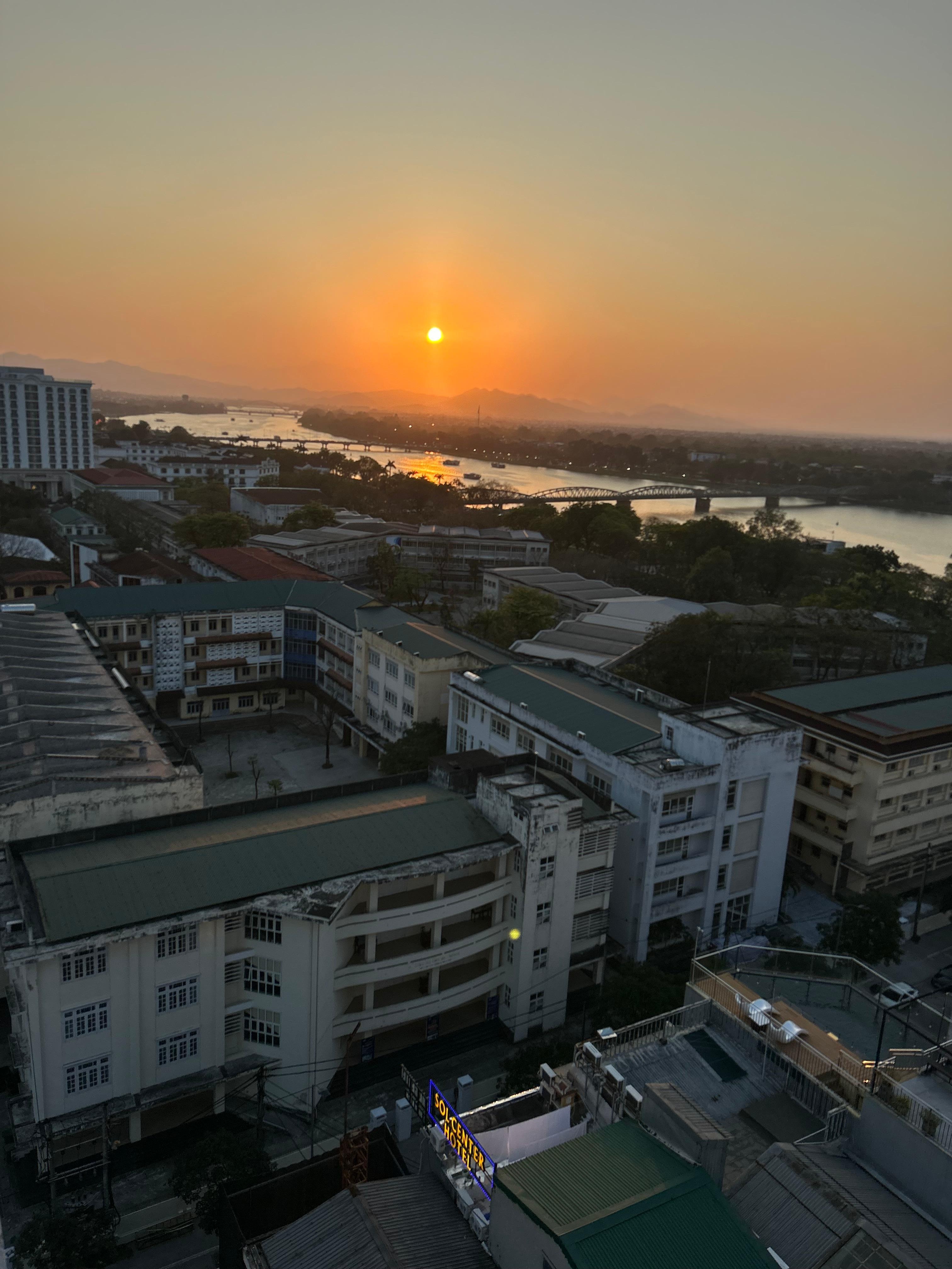 Sunset views of Hue from the rooftop with the Perfume River in sight.