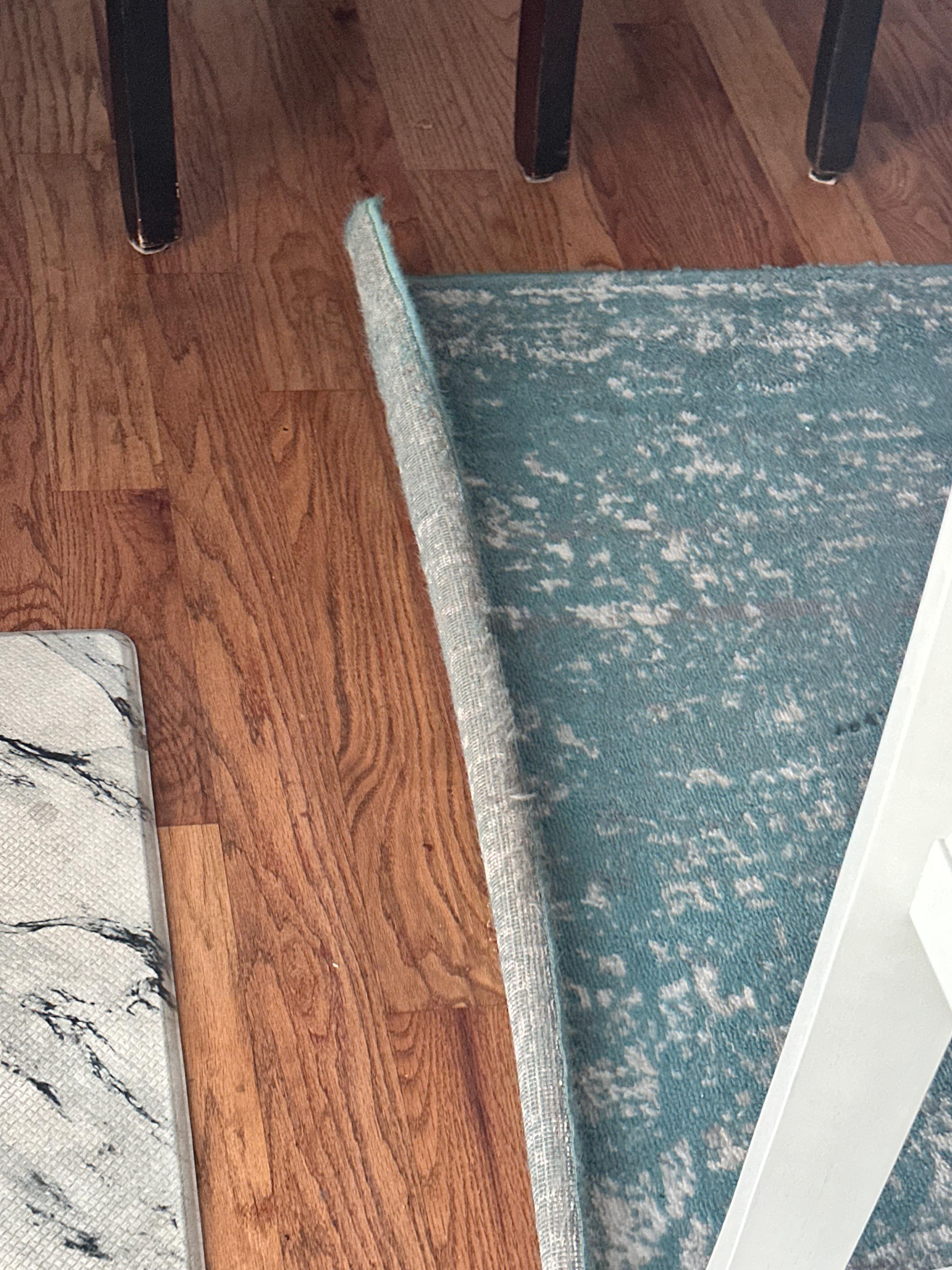 Area rug rolled up on edges.