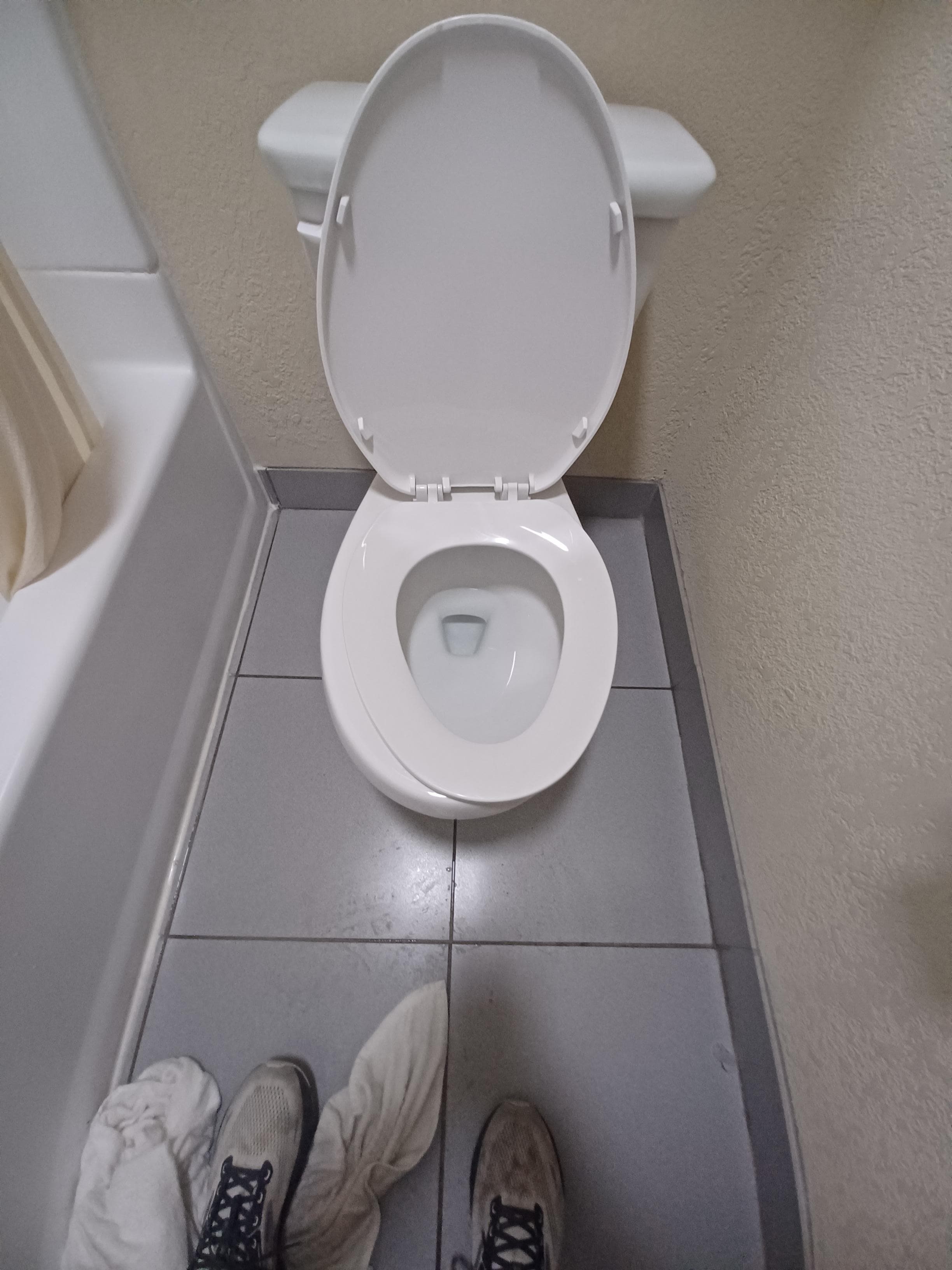 Misaligned toilet seat.