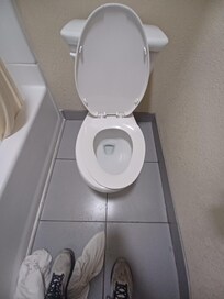 Misaligned toilet seat.