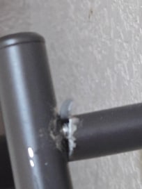 Broken toilet paper holder with with metal sticking up